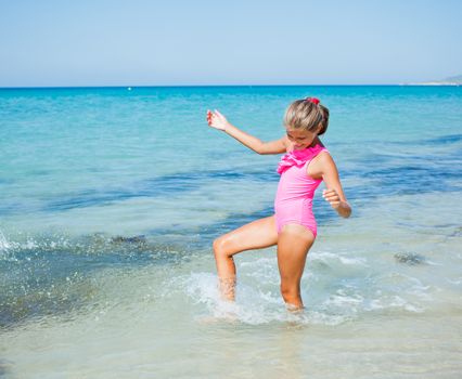 Beautiful happy smiling girl having fun on the beach.