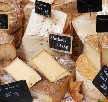 Random sorts of traditional french cheese for sale on rural market ot Provence, South France