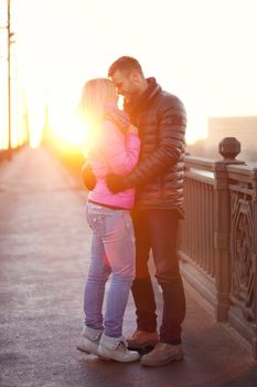 A pair of lovers are hugging and goodbying on the city bridge