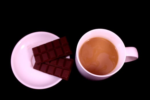 Cup of coffee and chocolate on a black background