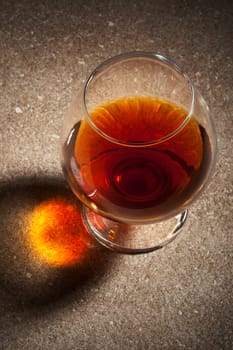 a glass of brandy on the marble table