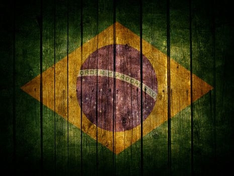 Very old dark brown wooden planks background with Brazil flag painted on it