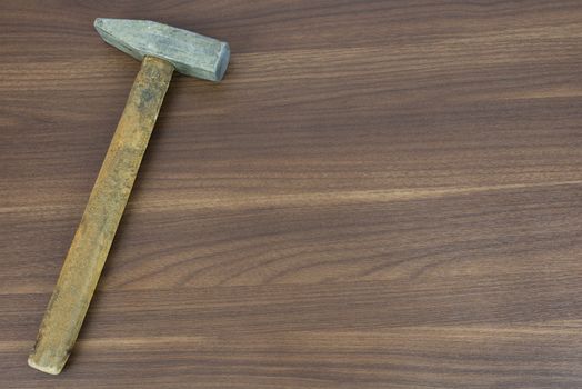 Old hammer on a wooden surface. carpenter tools