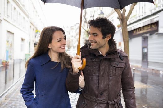 Happy  smiling woman man umbrella shower