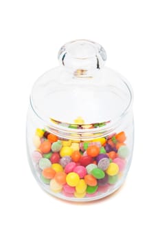 Candy in a glass jar on white background
