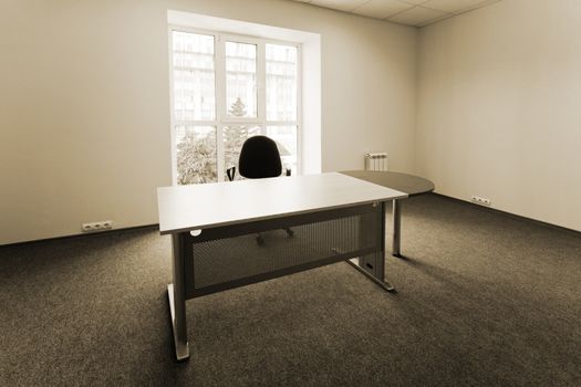 Chair and table at a window at modern office