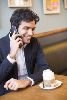 smiling male cheerful restaurant smartphone