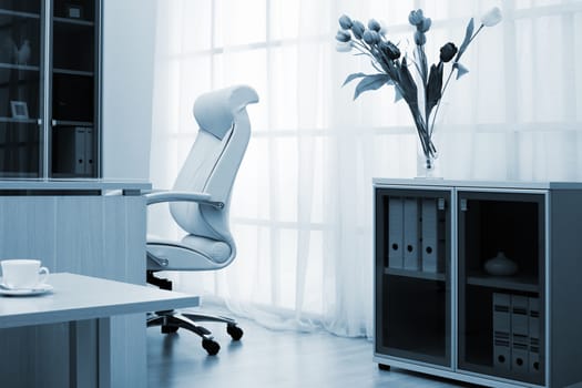 Flowers on a background of a window at modern office