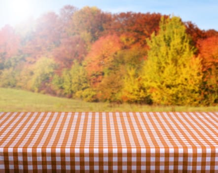 Empty wooden deck table with autumn background. Ready for product display montage.