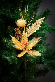 gold ornament on the artificial Christmas tree