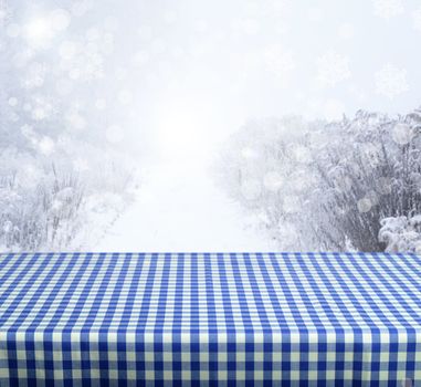 Empty blue table with winter background. Ready for product display montage.