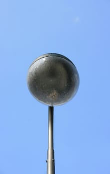 a street lamp with a large, spherical glass body