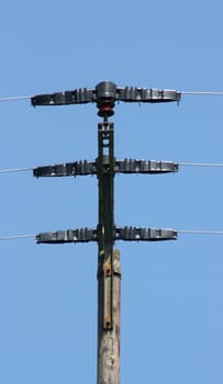 large transmission power pole, with blue sky background