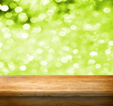 Empty wooden deck table with green background. Ready for product display montage.