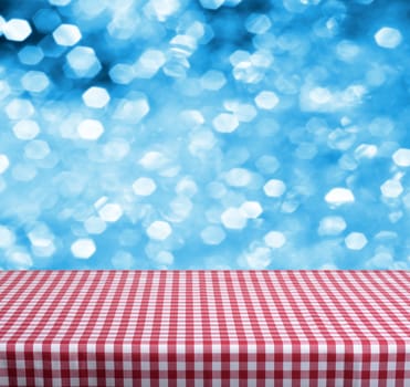 Empty wooden deck table with blue christmas background. Ready for product display montage.