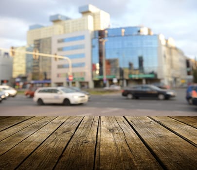 Empty wooden deck table with city in background. Ready for product display montage. 