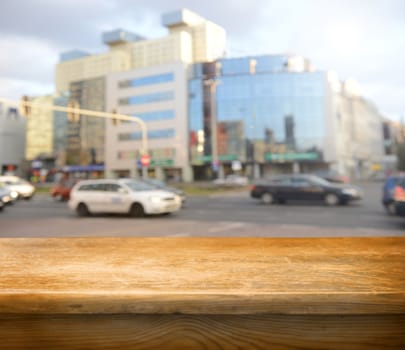 Empty wooden deck table with city in background. Ready for product display montage. 