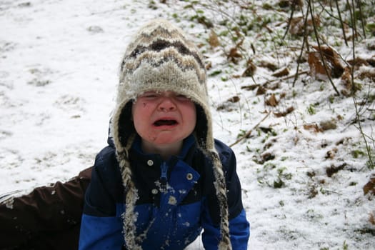 Boy crying in the snow.