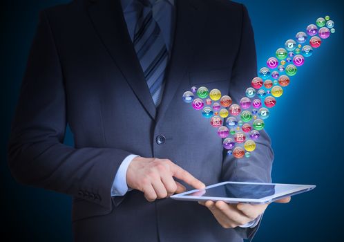 Businessman in a suit holding a tablet in his hands. Above the screen tablet application icons in the form of checkmark