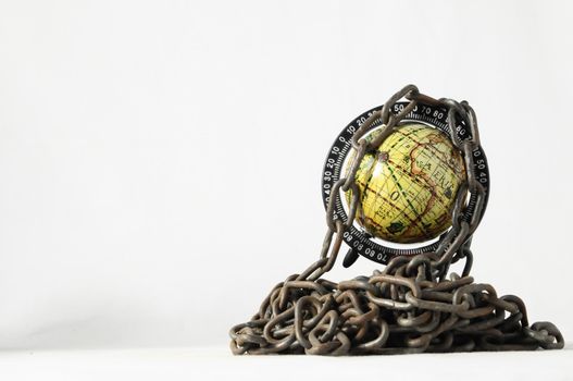 Earth globe close in chain and padlock