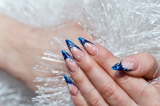 Crack nail polish on female fingers and beautiful jewels shot closeup