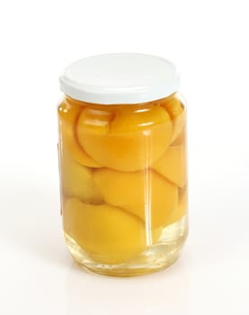 Glass jar of  peaches compote on white