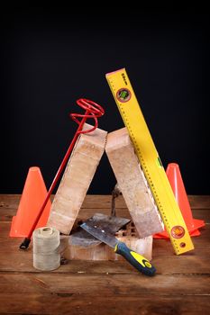 Bricks, trowel and stirrer on work place