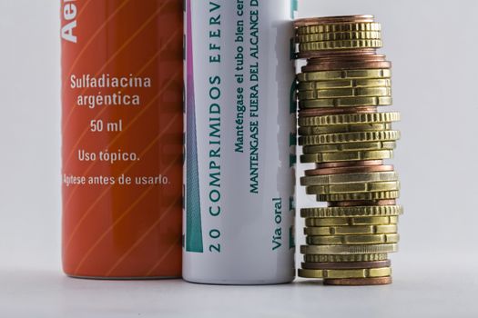 Effervescent tablets tubes together to euro coins, concept of copayment pharmacist