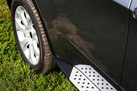 wheel of a modern car on the green grass