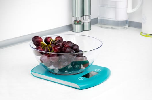 Grapes on scale in modern kitchen