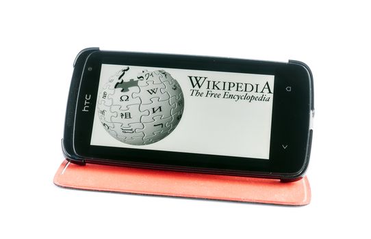 Bucharest, Romania - Jan 24, 2014: Photo of Wikipedia on smartphone screen. Wikipedia is a collaboratively edited, multilingual, free Internet encyclopedia that is supported by the non-profit Wikimedia Foundation
