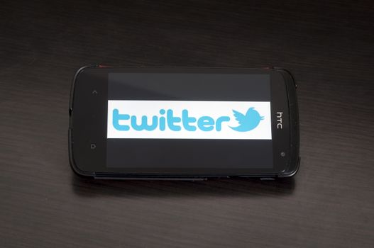 Bucharest, Romania - January 28, 2014: Photo of a HTC Desire device, showing the Twitter.com logo on a white background.