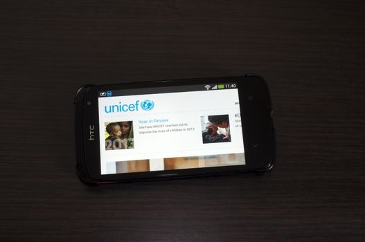 Bucharest, Romania - February 05, 2014: Photo of a HTC Desire device, showing the UNICEF web page.The UNICEF is a United Nations Program, that provides long-term humanitarian and developmental assistance to children and mothers in developing countries.