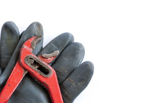 Tools and glove  over a white background with space for text