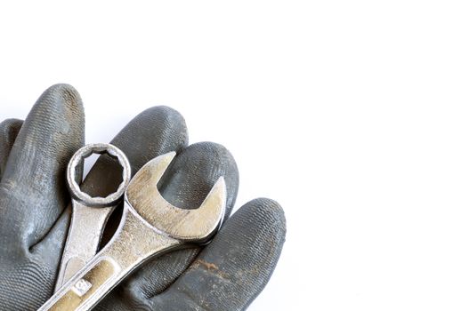 Set of tools and glove over a white background with space for text