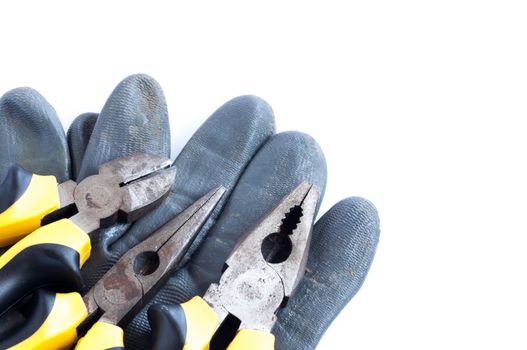 Set of tools and glove over a white background with space for text