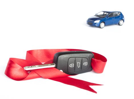 Gift car concept with red Bow and a blue car in the background.