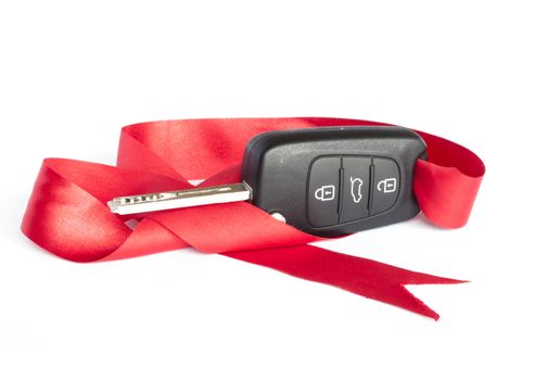 Gift key concept with red Bow on a white background.