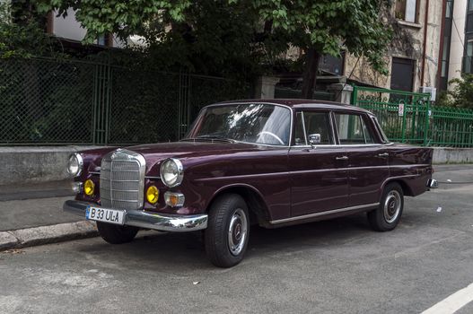 BUCHAREST-June 15: Classic Mercedes parked on the street. June15, 2013 in Bucharest, Romania. This model of Mercedes Benz was a top-range four-door sedan, produced from 1959 to 1968.