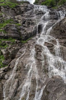 Small waterfall near Transfagarasan, a famous road in Romania, crossing the mountains.