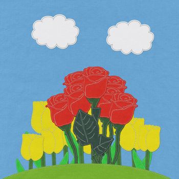 Red rose on green grass field with stitch style fabric background