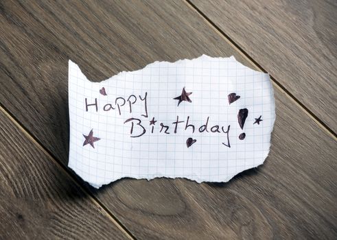 Happy Birthday - Hand writing text on wood background
