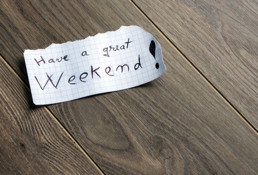 Have a great Weekend - Hand writing text on a piece of paper on wood background with space for text