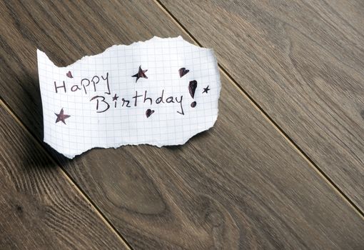 Happy Birthday - Hand writing text on wood background with space for text