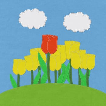 Tulip on green grass field with stitch style fabric background
