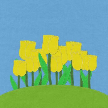 Tulip on green grass field with stitch style fabric background