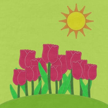 Tulip on green grass field with stitch style fabric background