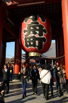 TOKYO, JAPAN - NOV 21: Imposing Buddhist structure features a massive paper lantern painted in vivid red-and-black tones to suggest thunder clouds and lightning at sensoji temple on November 21, 2013 in Tokyo, Japan.