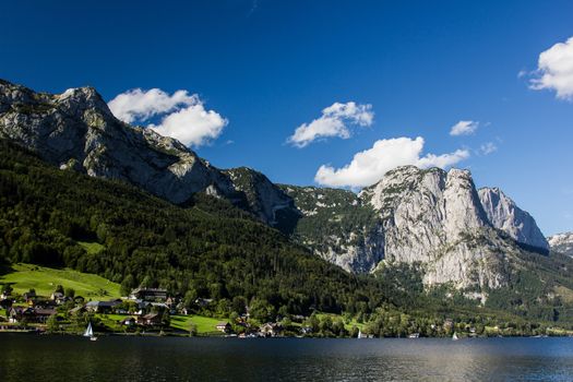 Small boat flowing on the lake in the mountains
