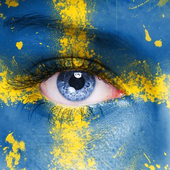Sweden flag painted on woman face